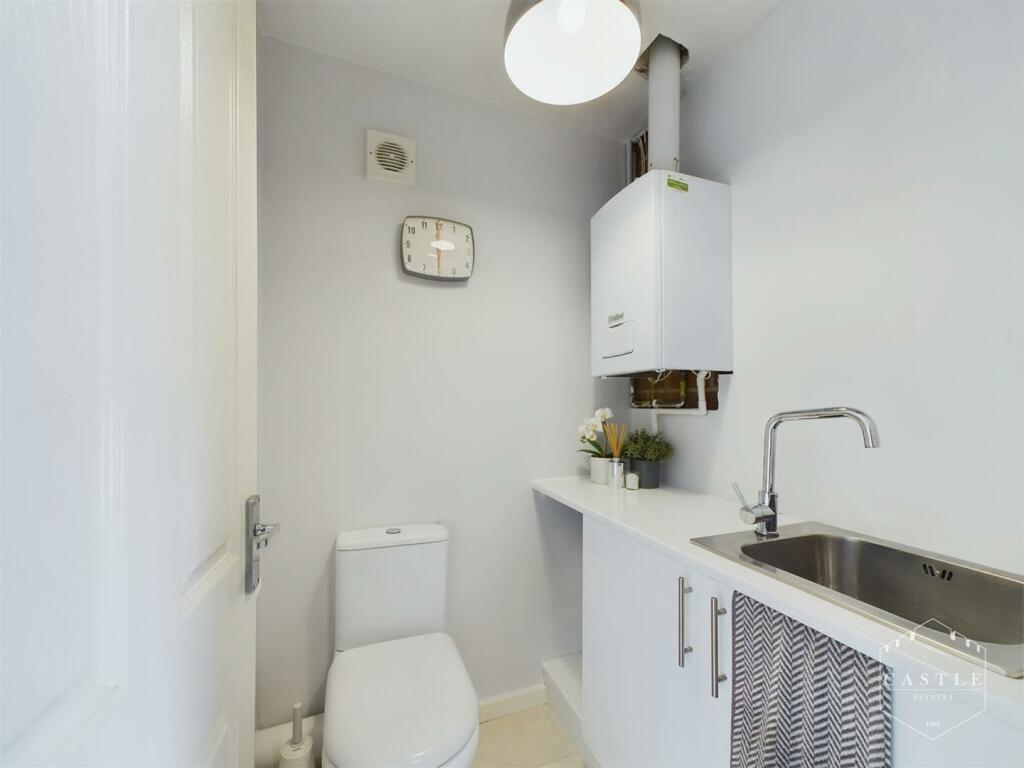 GUEST CLOAKROOM/UTILITY ROOM