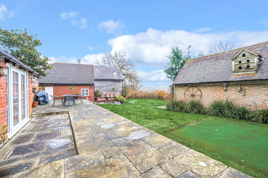 Private South East facing rear garden with outside seating areas and views over Ashdown Forest