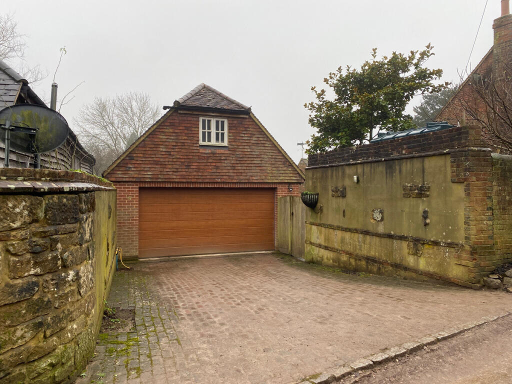 Detached double garage with parking for two vehicles inside and two more on the private driveway