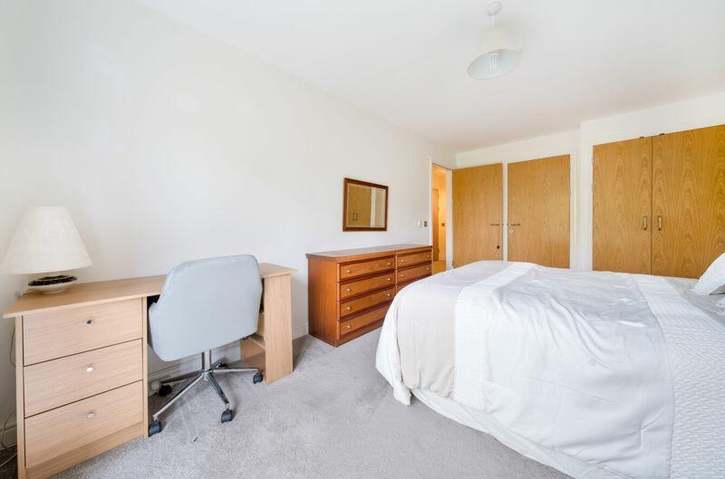 Bedroom with fitted wardrobes and ens...