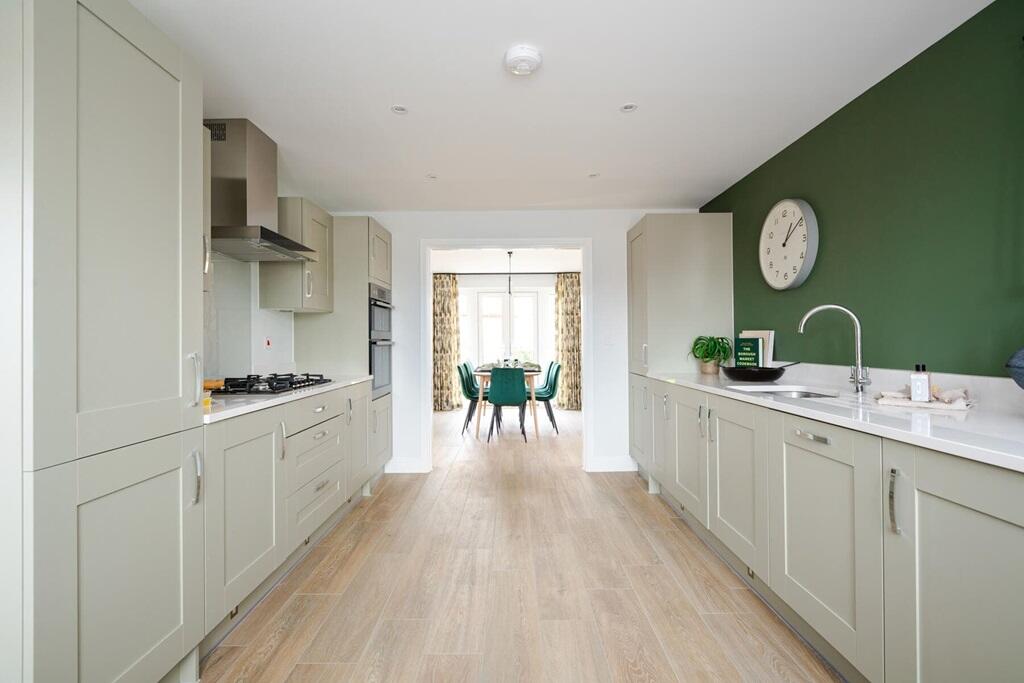 The kitchen leads through to the dining area with French doors to the garden