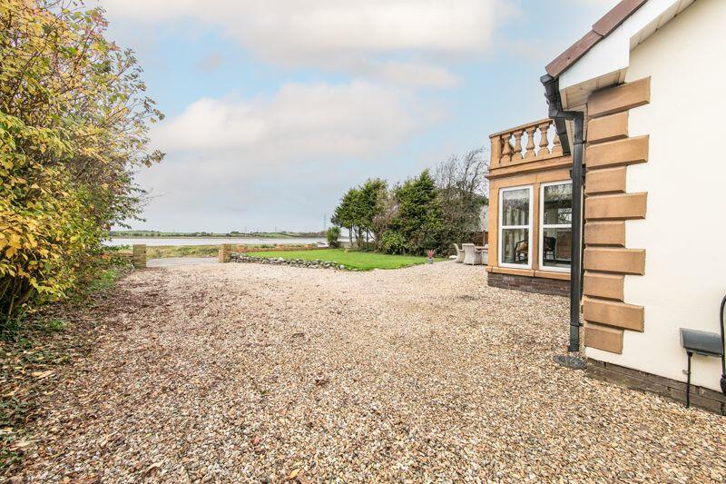 Front garden, driveway and estuary view