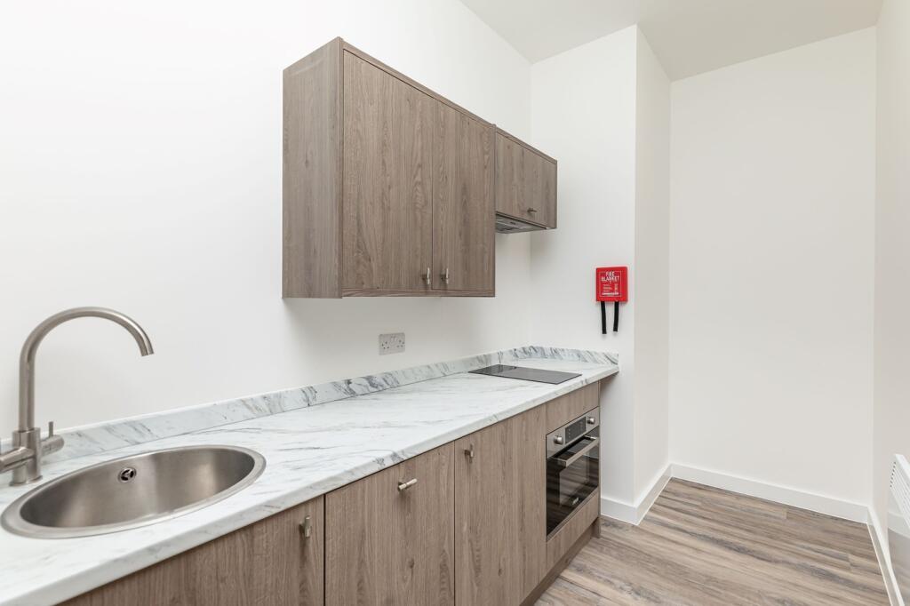 A modern kitchenette with clean lines and ample...