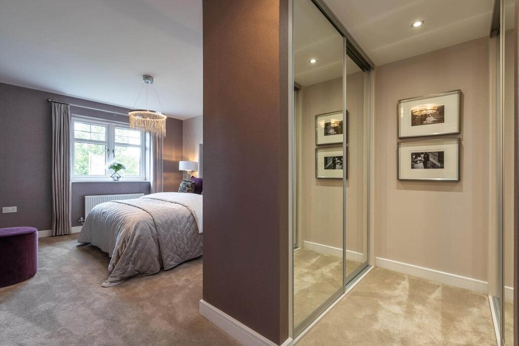 King size bedroom with dressing area and en suite shower room