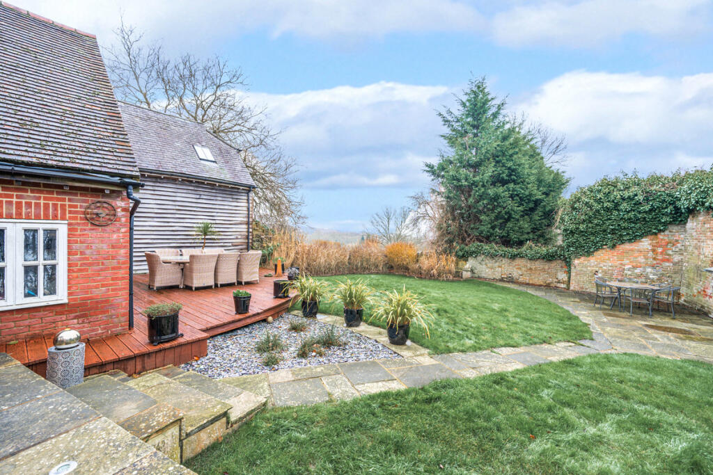 Private South East facing rear garden, decked area and far reaching views beyond of Ashdown Forest