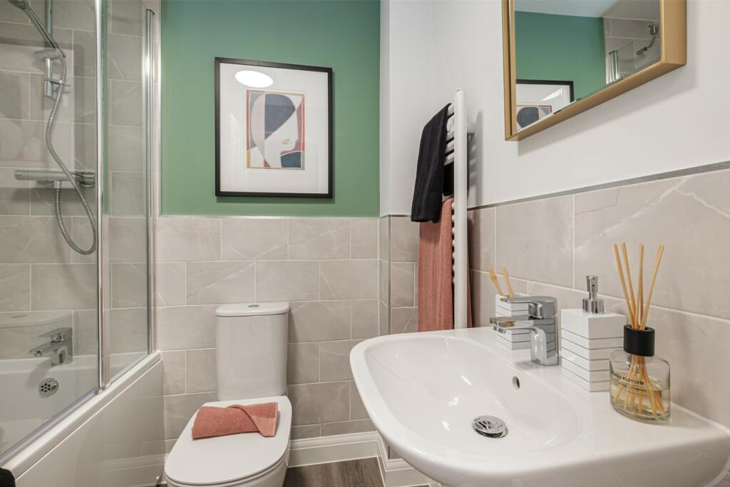 Bathroom with green painted wall above grey tiled wall