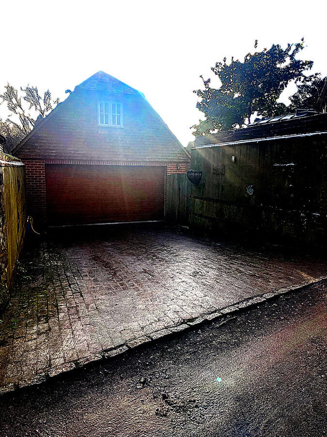 Detached double garage with parking for two vehicles inside and space for two vehicles on the driveway